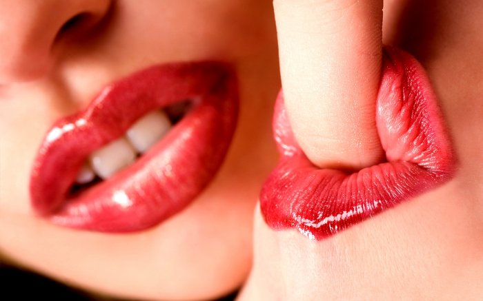 Lips and finger as a pleasant symbol of charm