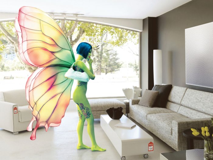 Pretty girl in a butterfly suit is choosing furniture in the salon