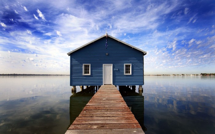 The cabin on the water with a flooring bridge