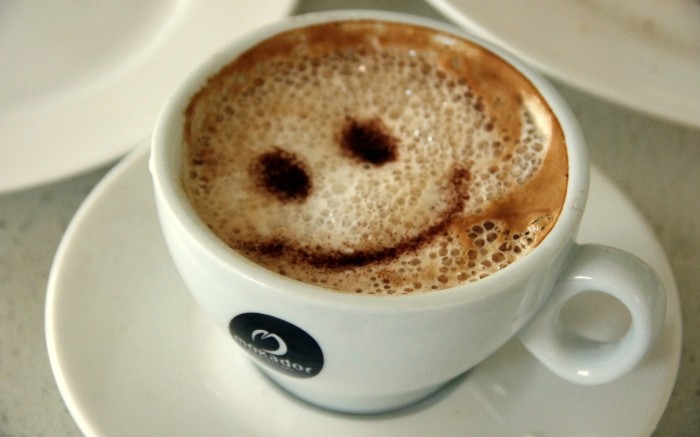 Smile on the foam of morning coffee