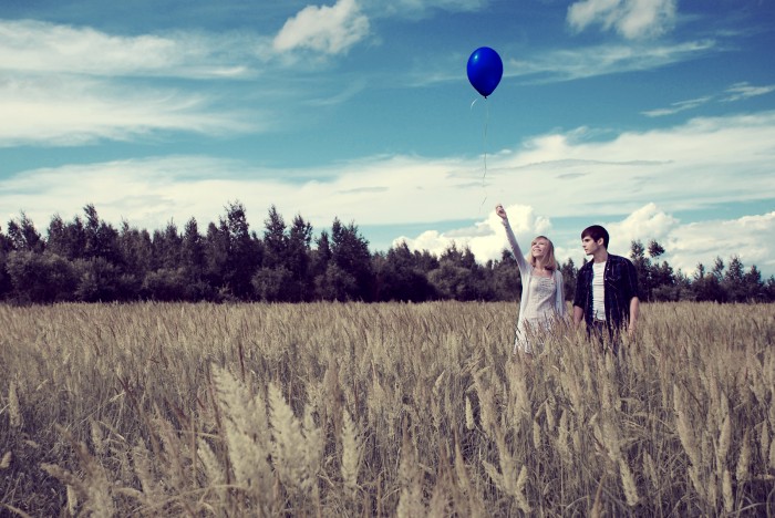 Couple with a blue ball in the field