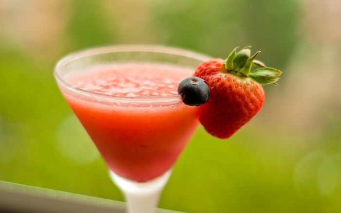 Cocktail with strawberries in a small glass