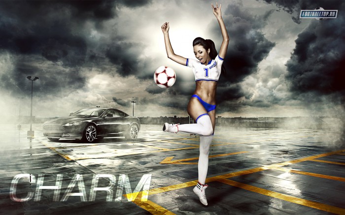 The picture shows a girl with arms raised, who juggles a soccer ball